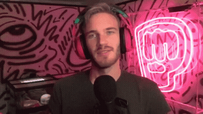 A Man Wearing Headphones Is Standing In Front Of A Microphone In Front Of A Neon Sign That Says P GIF