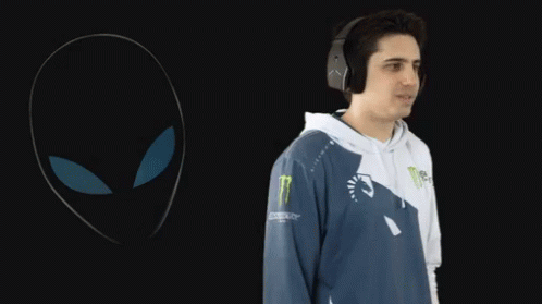 A Man Wearing Headphones Is Standing In Front Of A Monster Logo GIF
