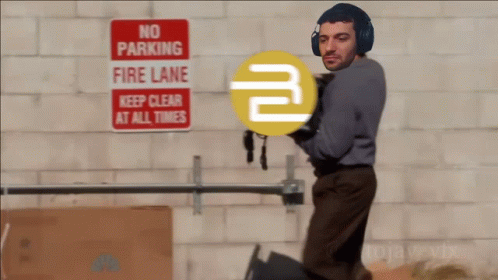 A Man Wearing Headphones Is Standing In Front Of A No Parking Fire Lane Sign GIF