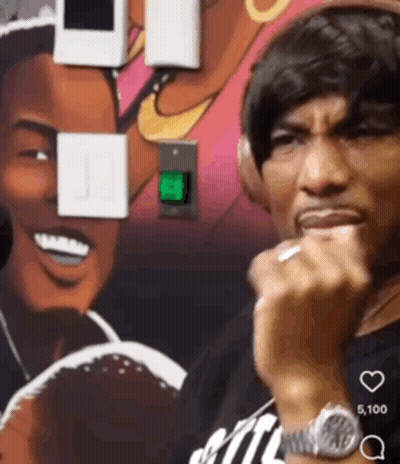 A Man Wearing Headphones Is Standing In Front Of A Painting GIF