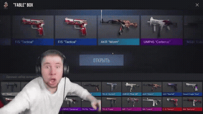 A Man Wearing Headphones Is Standing In Front Of A Rifle That Says Ump45 Cerberus Epic GIF