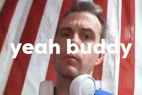 A Man Wearing Headphones Is Standing In Front Of An American Flag And The Words " Yeah Buddy " Are Above Him GIF