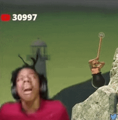 A Man Wearing Headphones Is Standing Next To A Rock And Holding A Hammer . GIF