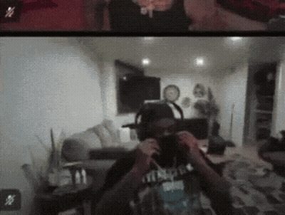 A Man Wearing Headphones Is Taking A Picture Of Himself In A Room GIF