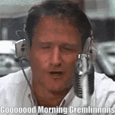 A Man Wearing Headphones Is Talking Into A Microphone And Saying Good Morning Gremlins . GIF