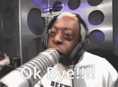 A Man Wearing Headphones Is Talking Into A Microphone And Says Ok Bye GIF