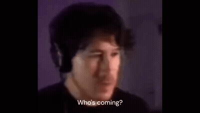 A Man Wearing Headphones Is Talking Into A Microphone In A Dark Room . GIF