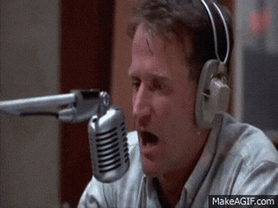 A Man Wearing Headphones Is Talking Into A Microphone .. GIF