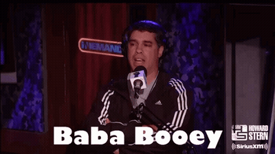 A Man Wearing Headphones Is Talking Into A Microphone With The Words Baba Booey Above Him GIF