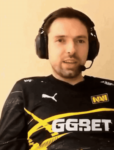 A Man Wearing Headphones Is Wearing A Shirt That Says Ggbet GIF