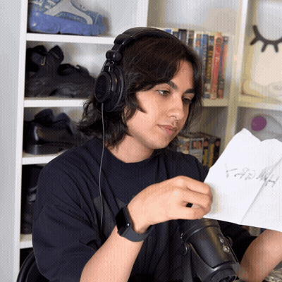 A Man Wearing Headphones Looks At A Piece Of Paper That Says ' Hash ' GIF