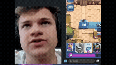 A Man Wearing Headphones Looks At A Screen With A Game In Progress GIF