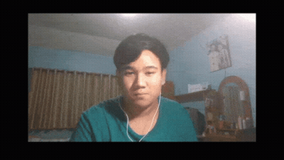 A Man Wearing Headphones Looks At The Camera In A Room GIF