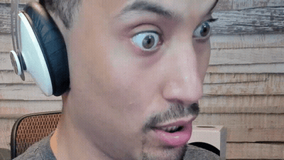 A Man Wearing Headphones Looks Surprised With His Mouth Open GIF