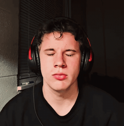 A Man Wearing Headphones Makes A Funny Face GIF