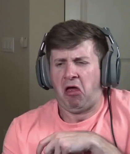 A Man Wearing Headphones Making A Funny Face . GIF