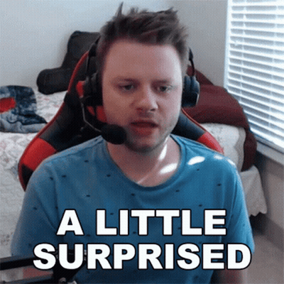 A Man Wearing Headphones Says A Little Surprised In Front Of A Window GIF