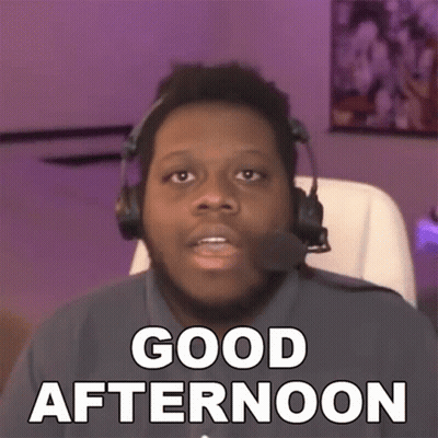 A Man Wearing Headphones Says " Good Afternoon " While Sitting In A Chair GIF