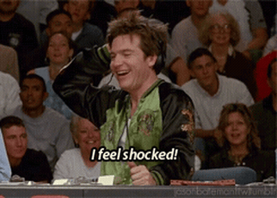A Man Wearing Headphones Says " I Feel Shocked " In Front Of A Crowd GIF