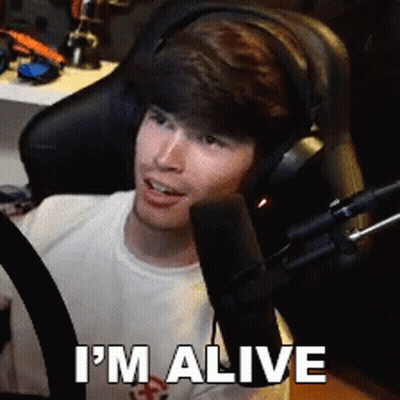 A Man Wearing Headphones Says I 'M Alive GIF