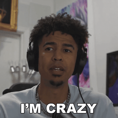 A Man Wearing Headphones Says " I 'M Crazy " In Front Of A Microphone GIF