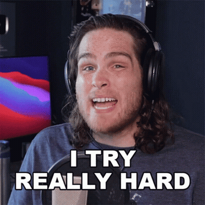 A Man Wearing Headphones Says " I Try Really Hard " In Front Of A Microphone GIF