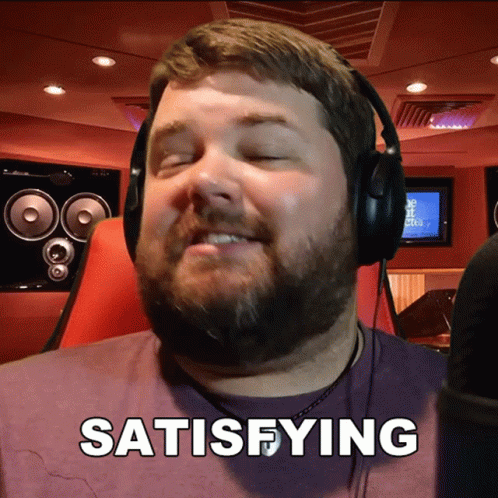 A Man Wearing Headphones Says Satisfying In Front Of A Microphone GIF