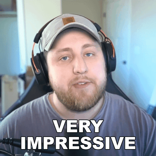 A Man Wearing Headphones Says Very Impressive In Front Of A Microphone GIF