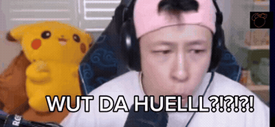 A Man Wearing Headphones Says Wut Da Huell In Front Of A Stuffed Pikachu GIF
