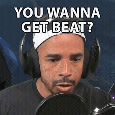 A Man Wearing Headphones Says " You Wanna Get Beat " In Front Of A Microphone GIF