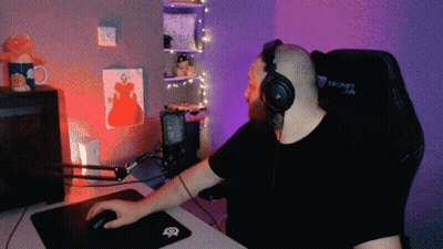 a man wearing headphones sits in a secret lab gaming chair
