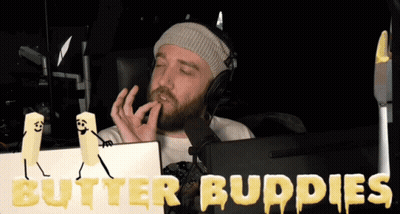 A Man Wearing Headphones Sits In Front Of A Computer Screen With Butter Buddies Written On The Screen GIF