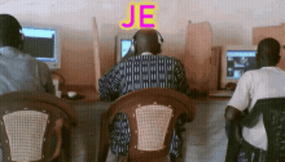 A Man Wearing Headphones Sits In Front Of A Computer With The Word Je Written Above Him GIF
