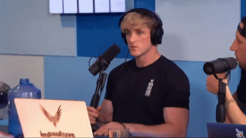 A Man Wearing Headphones Sits In Front Of A Laptop That Says Impulsive On It GIF