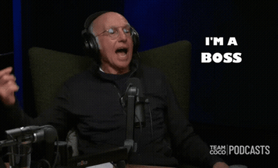 A Man Wearing Headphones Sits In Front Of A Microphone With The Words I 'M A Boss Behind Him GIF