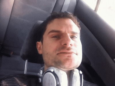 A Man Wearing Headphones Sitting In A Car GIF