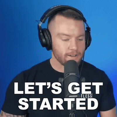 a man wearing headphones stands in front of a microphone and says " let 's get started "