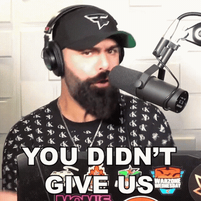 A Man Wearing Headphones Stands In Front Of A Microphone And Says You Didn 'T Give Us GIF