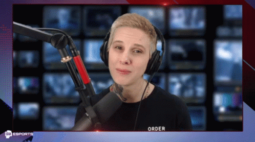 A Man Wearing Headphones Stands In Front Of A Microphone That Says Order On It GIF