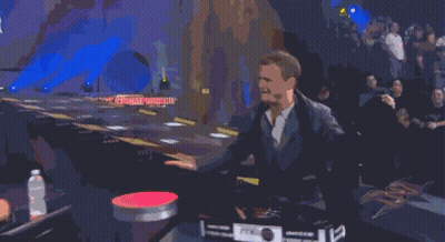 A Man Wearing Headphones Talks On A Cell Phone While Another Man Looks On GIF