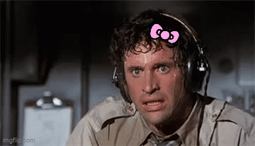 A Man Wearing Headphones With A Pink Bow On His Head Is Sweating . GIF