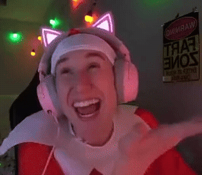 a man wearing headphones with glowing cat ears is smiling in front of a sign that says " warning "