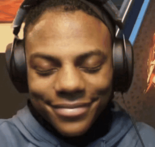 A Man Wearing Headphones With His Eyes Closed Smiles GIF