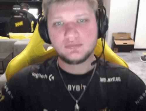 A Man Wearing Headphones With Logitech Written On His Shirt GIF