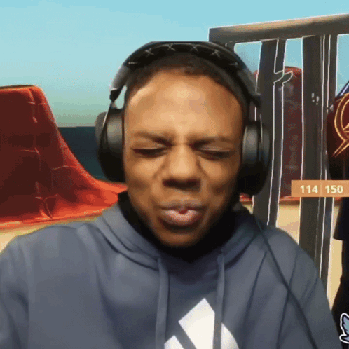 A Man Wearing Headphones With The Number 114 On The Bottom GIF
