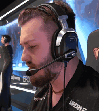 A Man Wearing Headphones With The Word Logitech On His Shirt GIF