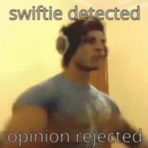 A Man Wearing Headphones With The Words Swiftie Detected Opinion Rejected Above Him GIF