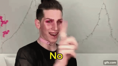 A Man Wearing Pink Makeup And A Choker Is Pointing At The Camera . GIF