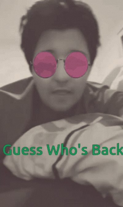 A Man Wearing Pink Sunglasses With The Words Guess Who 'S Back Above Him GIF