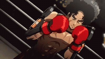 A Man Wearing Red Boxing Gloves Is Standing In A Boxing Ring GIF